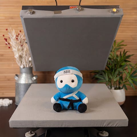 Ninja Transfers plushie on a heat press