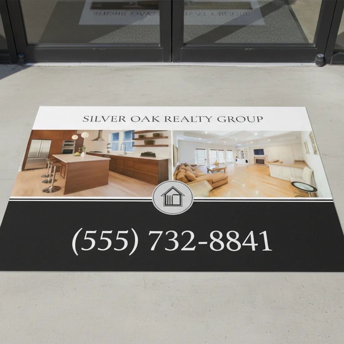Real estate promotional mat with 'Silver Oak Realty Group' contact information on a floor.
